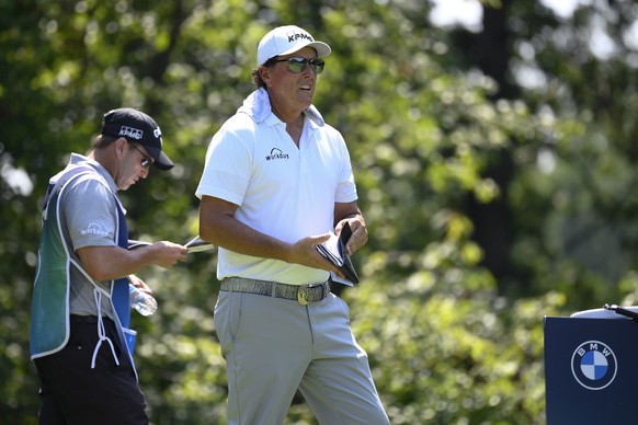 Phil Mickelson looks on before teeing off on the fifth hole during the first round of the BMW Championship golf tournament, Thursday, Aug. 26, 2021, at Caves Valley Golf Club in Owings Mills, Md. (AP  ...