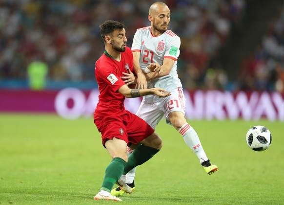 epa06811016 Bruno Fernandes (L) of Portugal in action against David Silva (R) of Spain during the FIFA World Cup 2018 group B preliminary round soccer match between Portugal and Spain in Sochi, Russia ...