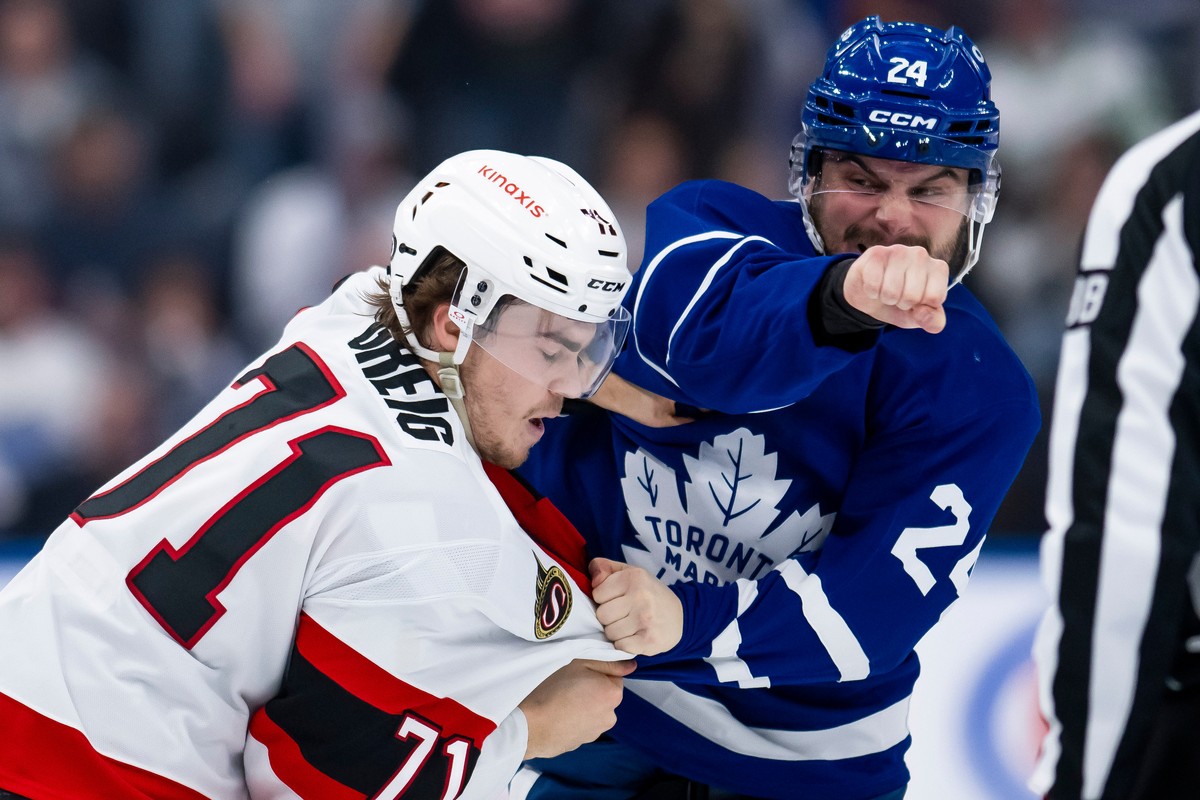 Toronto Maple Leafs left wing Scott Laughton (24) and Ottawa Senators center Ridly Greig (71) fight during the second period of an NHL hockey game in Toronto on Saturday, March 15, 2025. (Christopher  ...