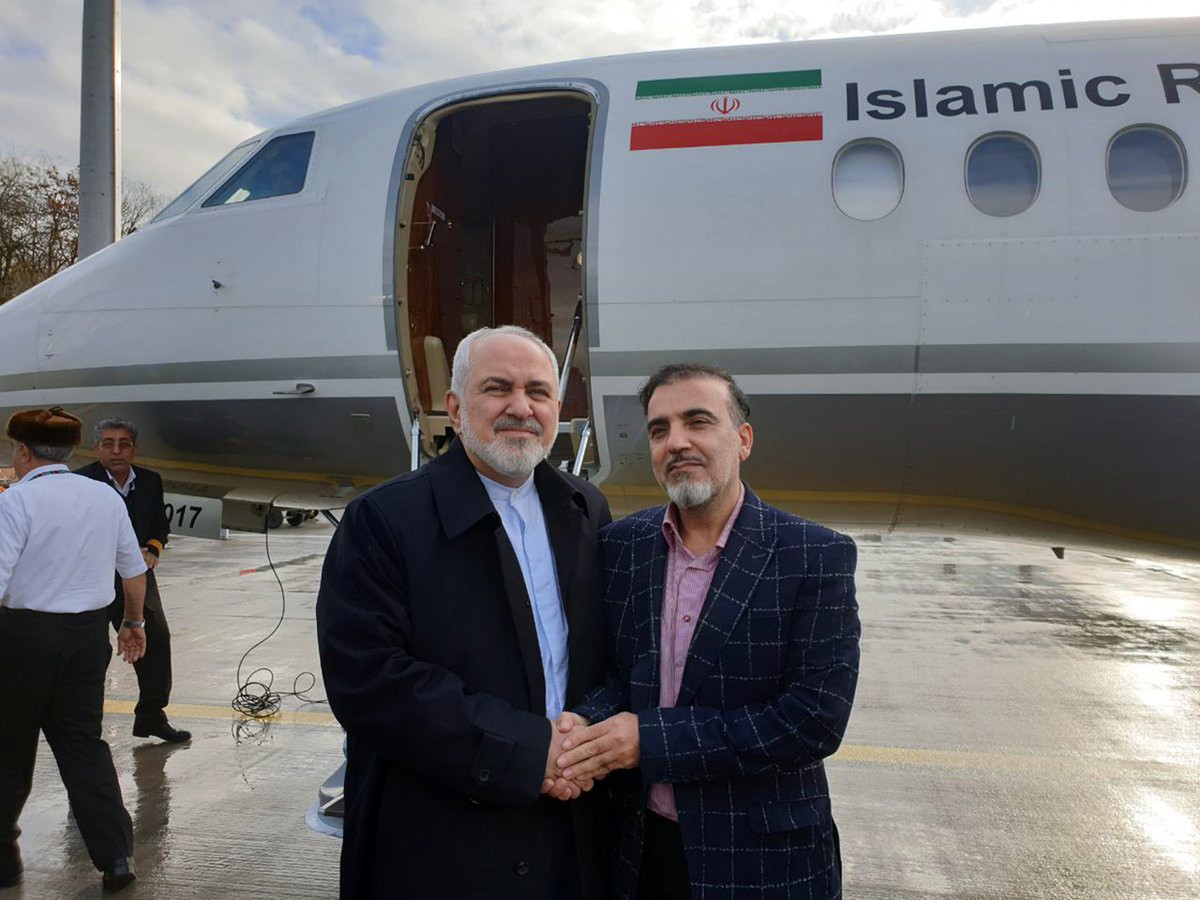 In this photo released on twitter account of Iran's Foreign Minister Mohammad Javad Zarif , Zarif, left, shakes hand with Iranian scientist Massoud Soleimani prior to leaving Zurich, Switzerland  ...