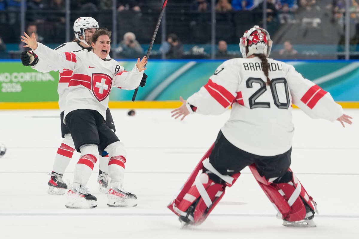 Switzerland's Alina Muller (25) celebrates with Switzerland's Andrea Braendli (20) after a women's ice hockey bronze medal game between Switzerland and Sweden at the 2026 Winter Olympic ...