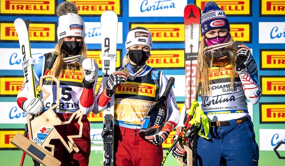 epa09004384 Lara Gut-Behrami (C) of Switzerland poses with her gold medal on the podium after winning the women&#039;s Super G race of the 2021 FIS Alpine Skiing World Championships in Cortina d&#039; ...