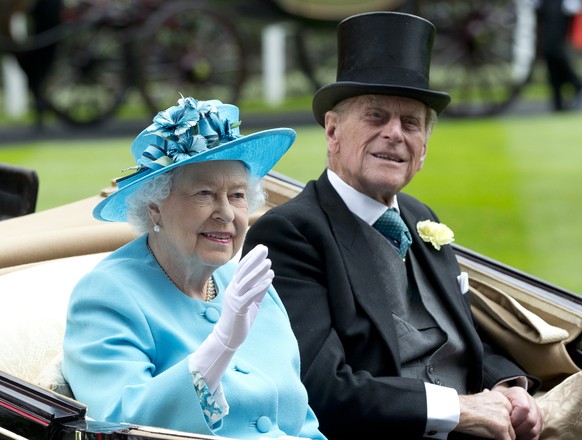 FILE - In this file photo dated Thursday, June, 19, 2014, Britain&#039;s Queen Elizabeth II, and Prince Philip arrive by carriage in the parade ring on the third day of the Royal Ascot horse racing me ...