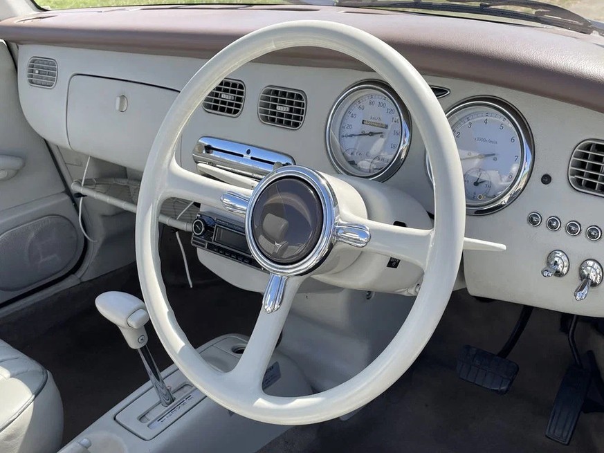 1991 Nissan Figaro 
https://www.route66auctions.com/product/nissan-figaro-1991-n8658-5/