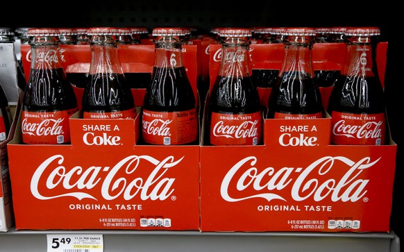 FILE--In this Aug. 8, 2018, file photo, bottles of Coca Cola sit on a shelf in a market in Pittsburgh. The Coca-Cola Company says that it's &quot;closely watching&quot; the growth of the use of a non- ...
