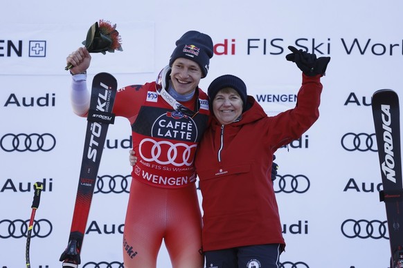 Switzerland's Marco Odermatt and Swiss Federal president Viola Amherd, celebrate after an alpine ski, men's World Cup downhill race, in Wengen, Switzerland, Saturday, Jan. 13, 2024. (AP Phot ...