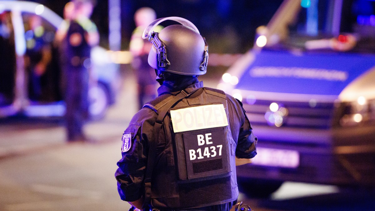 epa13133034 A police officer carrying a machine gun walks near the scene where several people were injured on the sideline of the Christopher Street Day (CSD) parade in Berlin, Germany, 25 July 2026.  ...