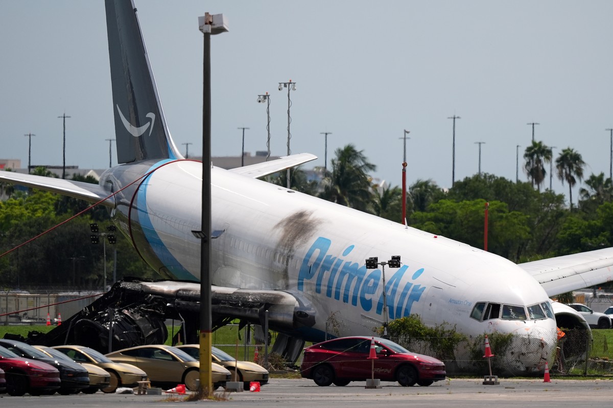 An Amazon cargo plane lies damaged near a parking lot two days after overshooting a runway at Miami International Airport, Tuesday, Sept. 8, 2026, in Miami. (AP Photo/Rebecca Blackwell)
Amazon Plane O ...