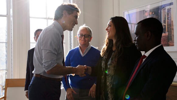 Canadian Prime Minister Justin Trudeau, left, participates in a discussion with LGBT rights advocates in the Commonwealth, who are part of the Commonwealth Equality Network, while in London, Thursday, ...