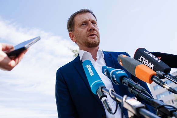 epa11401675 Saxony State Premier Michael Kretschmer talks to the media as he arrives to attend the Christian Democratic Union (CDU) party committee meetings at the party&#039;s headquarters in Berlin, ...