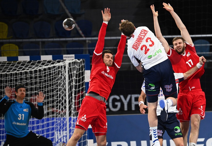 epa08942668 Switzerland&#039;s Michal Svajlen (L) and Samuel Rothlisberger (R) in action against Norway&#039;s Sogard Goran Johannessen (C) during the match between Switzerland and Norway at the 27th  ...