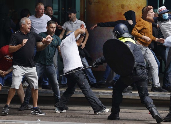 epa08500547 Police try to stop protesters in the center of The Hague, Netherlands, 21 June 2020. Demonstrators attended the protest on event venue Malieveld that focused on the coronavirus measures of ...