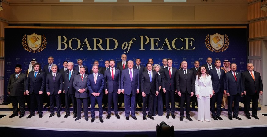 FILE - President Donald Trump stands with other World leaders before a Board of Peace meeting at the U.S. Institute of Peace, Feb. 19, 2026, in Washington. (AP Photo/Mark Schiefelbein, File)
Donald Tr ...