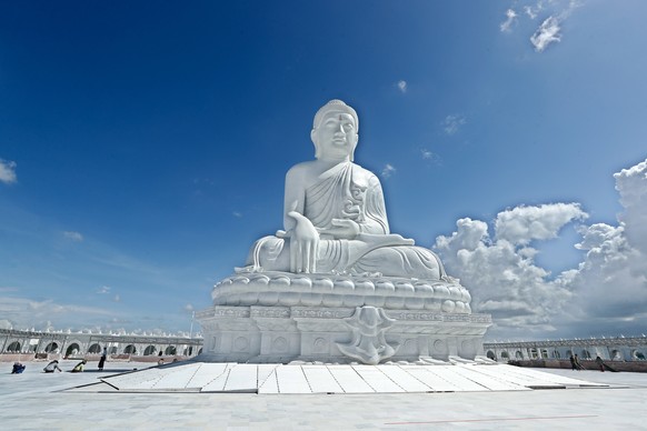 epa10759938 Workers fix the floor tiles at the construction site of the Maravijaya Buddha Image in Naypyitaw, Myanmar, 21 July 2023. The statue, which is 81 feet (25 m) and weighs 2,100 tons, would be ...