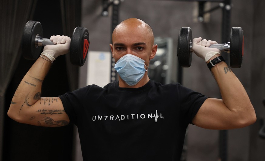 epa08457909 Customers work out in a sport center that has reopened during the Phase Two of the coronavirus lockdown in Brescia, Italy, 25 May 2020. Several countries around the globe have started to e ...