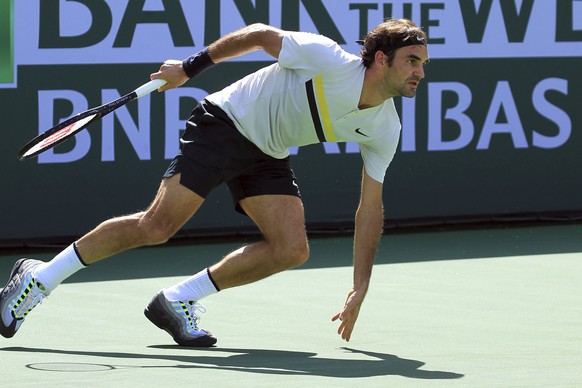 Roger Federer pivots to chase down a shot from Filip Krajinovic during the third round of the BNP Paribas Open tennis tournament at the Indian Wells Tennis Garden in Indian Wells, Calif., Monday, Marc ...