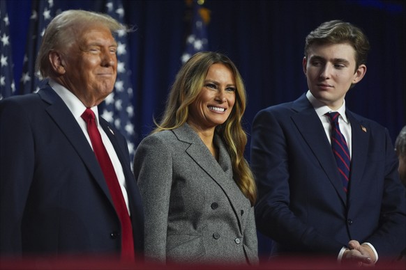 Republican presidential nominee former President Donald Trump, former first lady Melania Trump and Barron Trump listen at an election night watch party at the Palm Beach Convention Center, Wednesday,  ...