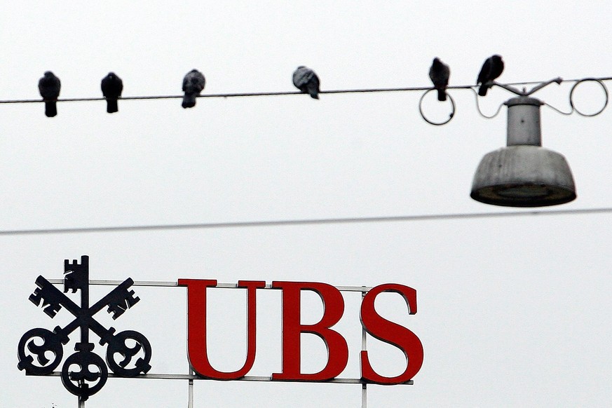 epa08963650 (FILE) - A file photo dated 17 September 2008 showing doves sitting on power lines over the Logo of UBS at Paradeplatz in Zurich, Switzerland (reissued 25 January 2021). UBS is to release  ...