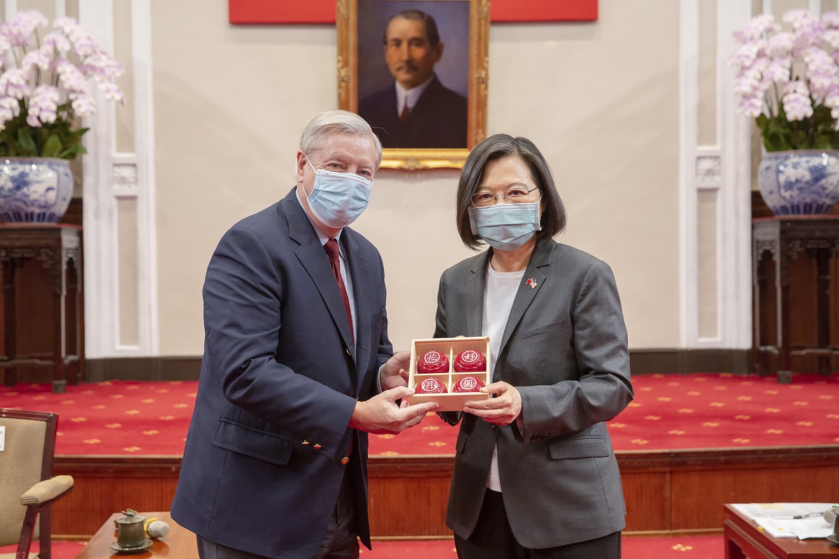 In this photo released by the Taiwan Presidential Office, Sen. Lindsey Graham, R-S.C., left, and Taiwan's President Tsai Ing-wen, right, pose for a photo during a meeting at the Presidential Offi ...