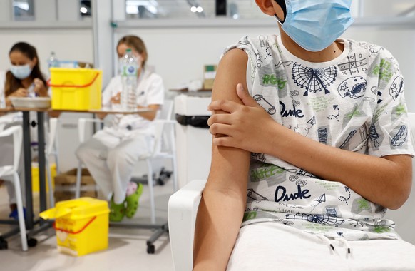 epa09409456 A teenager waits after he received a dose of a vaccine against COVID-19 at a hospital in Madrid, Spain, 11 August 2021. Madrid begins to vaccinate children over 12 years old, a measure tha ...