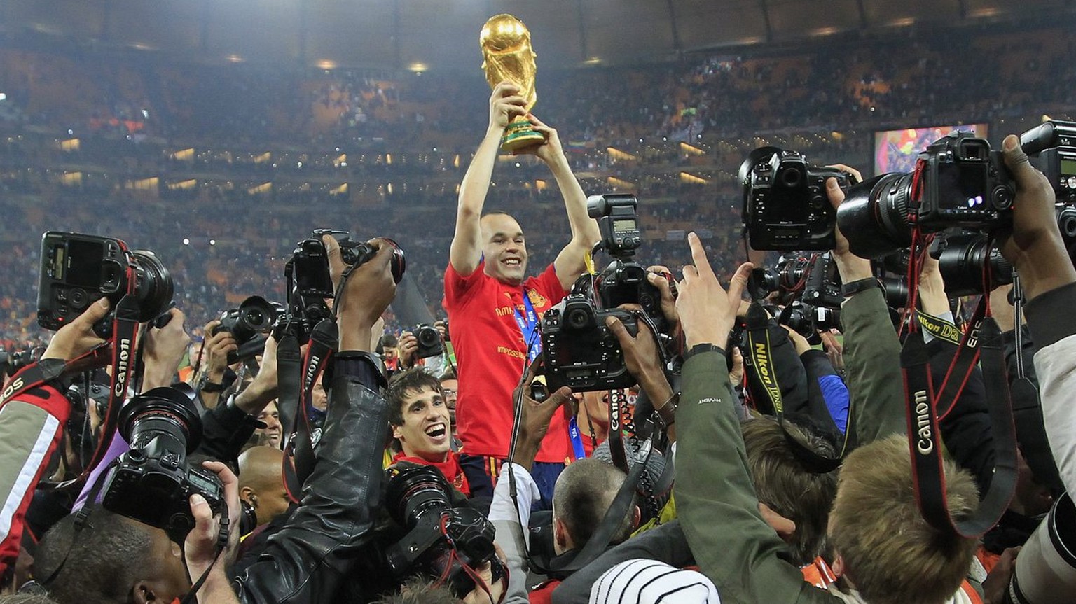 Spain&#039;s Andres Iniesta celebrates with the trophy after winning the 2010 FIFA soccer World Cup final between the Netherlands and Spain in the Soccer City Stadium in Johannesburg, South Africa, pi ...