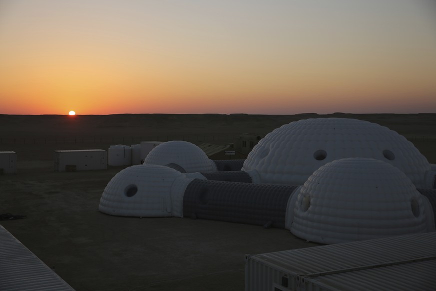 The sun rises over a 2.4-ton inflated habitat used by the AMADEE-18 Mars simulation in the Dhofar desert of southern Oman on Thursday, Feb. 8, 2018. The desolate desert in southern Oman resembles Mars ...