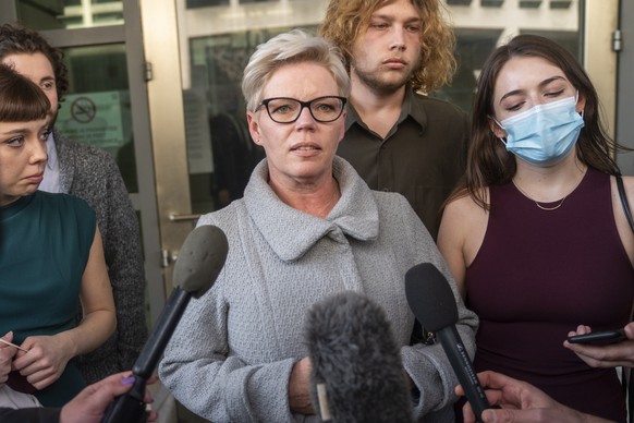 epa09811092 Nicole Reffitt (C), with her daughters Sara (L) and Peyton (R), responds to a question from the news media as she departs the federal court house in Washington, DC, USA 08 March 2022. Reff ...