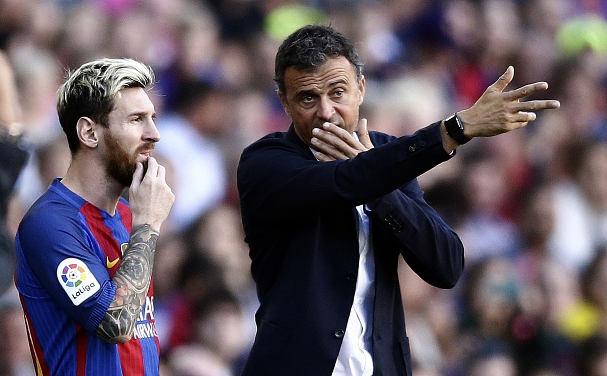 FC Barcelona's Lionel Messi, left, talks with his coach Luis Enrique during the Spanish La Liga soccer match between FC Barcelona and Deportivo Coruna at the Camp Nou in Barcelona, Spain, Saturda ...