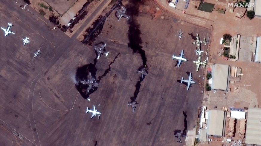 epa10577398 A handout satellite image made available by Maxar Technologies shows smoke billowing from destroyed aircrafts at Khartoum International Airport, in Khartoum, Sudan, 17 April 2023. Heavy gu ...