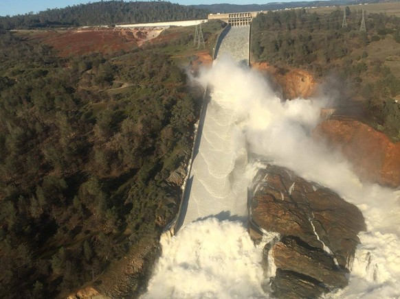 A damaged spillway with eroded hillside is seen in an aerial photo taken over the Oroville Dam in Oroville, California, U.S. February 11, 2017. California Department of Water Resources/William Croyle/ ...