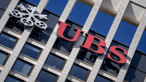 FILE - The logo of Swiss bank UBS is fixed on a building where the bank has offices in Frankfurt, Germany, Nov. 8, 2022. Swiss banking giant UBS will pay nearly $400 million in fines to U.S., Swiss an ...