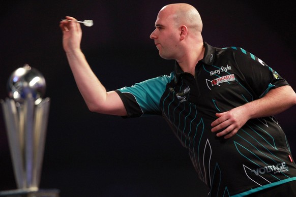 epa06413075 Rob Cross of England in action against Phil Taylor of England (not seen) during their PDC World darts final match at the Alexander Palace in North London, Britain, 01 January 2018. EPA/SEA ...