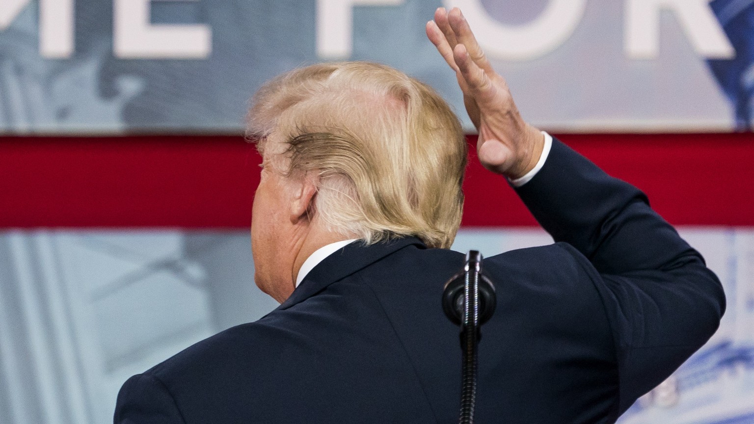 epa08703002 (FILE) - US President Donald J. Trump pretends to fix his hair as he addresses the 45th annual Conservative Political Action Conference (CPAC) at the Gaylord National Resort &amp; Conventi ...