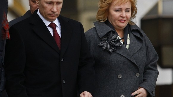 FILE - In this Sunday, March 4, 2012 file photo then Russian Prime Minister and presidential candidate Vladimir Putin and his wife Lyudmila leave a polling station in Moscow, Russia.  Russian President Vladimir Putin and his wife Lyudmila have announced they are divorcing.  Married just a few weeks short of 30 years, the Putins announced the decision on state television after attending a ballet performance Thursday evening in the Kremlin.( AP Photo/Alexander Zemlianichenko, file)