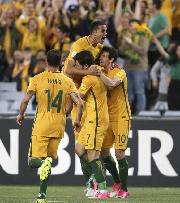 Australia&#039;s Tim Cahill, tops, celebrates with teammates after scoring against Syria during their Soccer World Cup qualifying match in Sydney, Australia, Tuesday, Oct. 10, 2017. (AP Photo/Rick Ryc ...