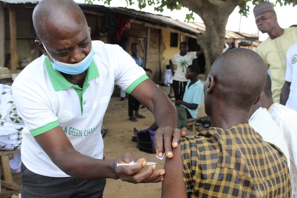 A Muslim faithful is administered a Moderna COVD-19 vaccination outside the Kuje, Central Mosque outskirts of Abuja, Friday, Oct. 8, 2021. Nigeria has begun the second rollout of COVID-19 vaccines as  ...