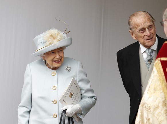 Britain&#039;s Queen Elizabeth II, and Prince Philip wait for the arrival by open carriage of Princess Eugenie of York and Jack Brooksbank following their wedding in St George&#039;s Chapel, Windsor C ...