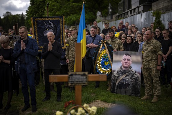 FILE - Relatives and friends attend the funeral of Melnyk Andriy, 23, a Ukrainian military servicemen who as killed in Kharkiv province, in Lviv, Ukraine, Saturday, May 14, 2022. Ukraine&#039;s Defens ...