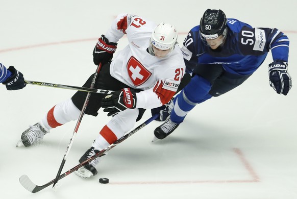 Finland&#039;s Juuso Rikola, right, challenges for the puck with Switzerland&#039;s Kevin Fiala, left, during the Ice Hockey World Championships quarterfinal match between Finland and Switzerland at t ...