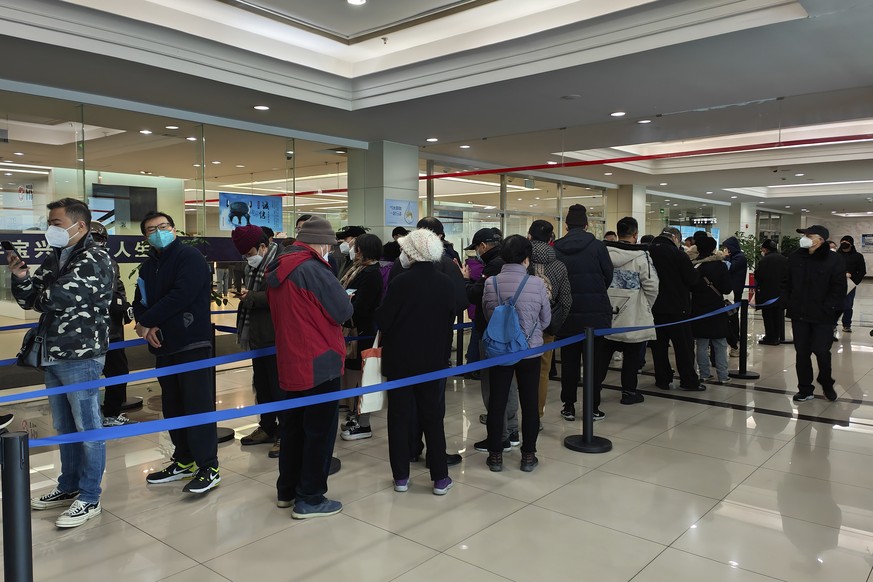 Family members of the deceased line up for the cremation procedures at a funeral home in Shanghai, China on Jan. 4, 2023. China on Saturday, Jan. 14, reported nearly 60,000 deaths in people who had CO ...