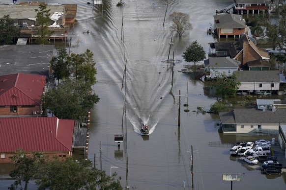 An Airboat glides over a city street in the aftermath of Hurricane Ida, Monday, Aug. 30, 2021, in Lafitte, La. (AP Photo/David J. Phillip)