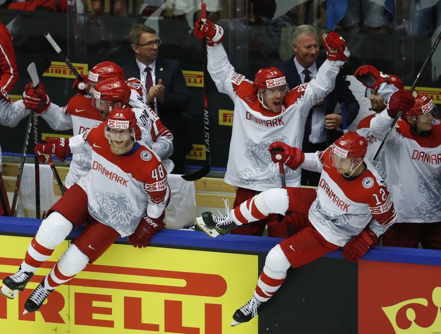 Players of Denmark celebrate after winning the Ice Hockey World Championships group B match between Finland and Denmark at the Jyske Bank Boxen arena in Herning, Denmark, Wednesday, May 9, 2018. (AP P ...