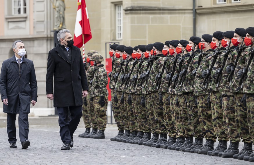 Swiss Federal President Ignazio Cassis, left, and his guest Karl Nehammer, Chancellor of Austria, pass the guard of honour of the Swiss Army during an official visit, in Zofingen, Switzerland, on Mond ...