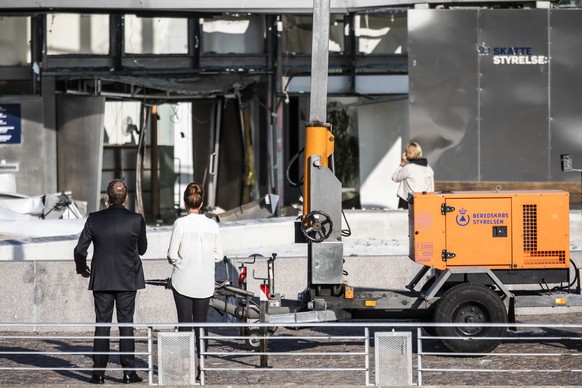 Director of the Tax Agency Merete Agergaard, right, and Minister of Taxation Morten Boedskov view damage caused by an explosion to the entrance of the Danish Tax Authority in Copenhagen, Denmark, Wedn ...