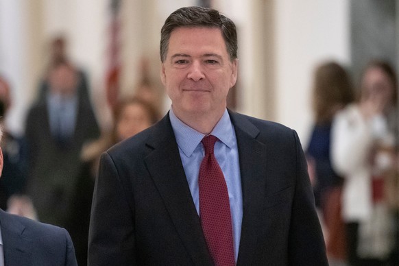 FILE - Former FBI Director James Comey, arrivex to testify under subpoena behind closed doors before the House Judiciary and Oversight Committee on Capitol Hill in Washington, Dec. 7, 2018. (AP Photo/ ...