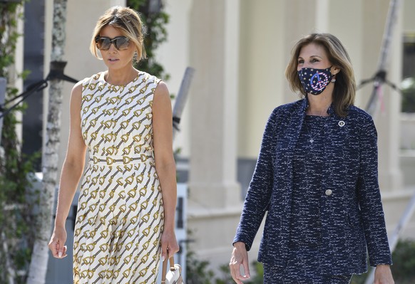 First lady Melania Trump walks with Wendy Sartory Link, Palm Beach County Supervisor of Elections, right, after voting at the Morton and Barbara Mandel Recreation Center, Tuesday, Nov. 3, 2020, in Pal ...