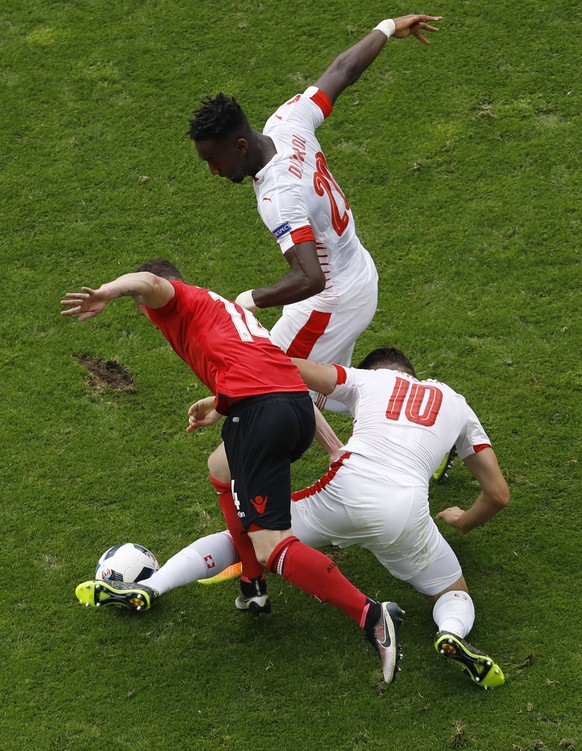 Switzerland&#039;s Granit Xhaka, right and his brother playing for AlbaniaTaulant Xhaka fight for the ball during the Euro 2016 Group A soccer match between Albania and Switzerland, at the Bollaert st ...