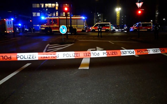 epa10512739 Emergency workers and police gather at the scene of a shooting in Hamburg, Germany, 09 March 2023. According to police, the shooting took place around 9 pm, killing seven people and injuri ...