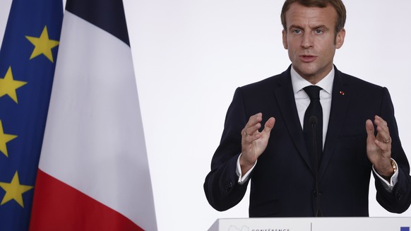 French President Emmanuel Macron speaks during a press conference folowing a conference on Libya in Paris Friday, Nov. 12, 2021. France is hosting an international conference on Libya on Friday as the ...