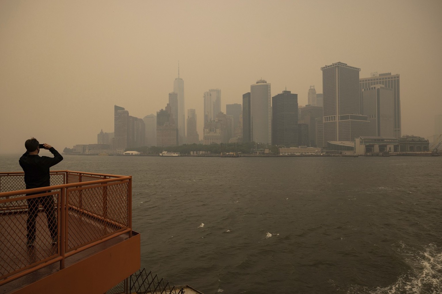 New York City is seen in a haze-filled sky, photographed from Staten Island Ferry, Wednesday, June 7, 2023, in New York. (AP Photo/Yuki Iwamura)